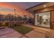 Picturesque backyard with modern patio design, hanging lounge chairs, and desert landscaping at sunset at 9502 N 47Th St, Phoenix, AZ 85028