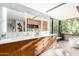 Bathroom with dual vanity, modern lighting, sleek countertop, and large window views at 9502 N 47Th St, Phoenix, AZ 85028