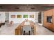 Elegant dining room with a long wooden table, bench seating, and modern artwork at 9502 N 47Th St, Phoenix, AZ 85028