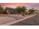 Striking contemporary home featuring desert landscaping and a unique architectural design at dusk at 9502 N 47Th St, Phoenix, AZ 85028