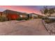 Modern home exterior with a long driveway leading to a multi-car garage, set against a mountain backdrop at 9502 N 47Th St, Phoenix, AZ 85028