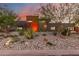 Modern home with desert landscaping, featuring a mix of rocks, cacti, and flowering plants at 9502 N 47Th St, Phoenix, AZ 85028