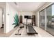 Bright home gym featuring a treadmill, rowing machine, and sliding glass doors to the outdoor area at 9502 N 47Th St, Phoenix, AZ 85028