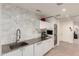 Modern kitchen with stainless steel countertops, marble backsplash, and white cabinetry at 9502 N 47Th St, Phoenix, AZ 85028