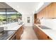 Bright, modern kitchen with white countertops, wood cabinets, and scenic backyard view at 9502 N 47Th St, Phoenix, AZ 85028