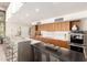 Modern kitchen with wood cabinets, a sleek island, and stainless steel appliances at 9502 N 47Th St, Phoenix, AZ 85028