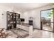 Stylish home office space with custom shelving, a modern desk, and an open view to the outside patio at 9502 N 47Th St, Phoenix, AZ 85028
