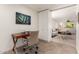 Inviting home office space with sleek desk, modern art, and open doorway to light filled living room at 9502 N 47Th St, Phoenix, AZ 85028