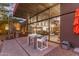 Outdoor patio with dining and grilling area, showcasing indoor/outdoor living through expansive glass windows at 9502 N 47Th St, Phoenix, AZ 85028