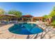 Refreshing backyard pool with ample seating, sun umbrellas, and modern architecture, perfect for relaxation and entertainment at 9502 N 47Th St, Phoenix, AZ 85028
