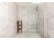 Modern shower with marble tiling and a glass enclosure, showcasing a clean and elegant design at 9502 N 47Th St, Phoenix, AZ 85028