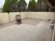 A patio with a partial view, featuring mature trees beyond the perimeter wall at 973 Leisure World --, Mesa, AZ 85206
