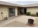 Spacious patio area featuring a built-in fire pit and easy access through a sliding glass door at 973 Leisure World --, Mesa, AZ 85206