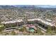 Scenic aerial view of the community, featuring a pool and mountain views in the distance and city views beyond at 9820 N Central Ave # 303, Phoenix, AZ 85020