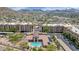 Scenic aerial view of the complex, featuring a pool, lush landscaping and mountain views in the distance at 9820 N Central Ave # 303, Phoenix, AZ 85020
