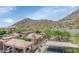 Aerial view of the community showcasing desert landscaping, covered parking, and mountain views with desert surroundings at 9820 N Central Ave # 303, Phoenix, AZ 85020