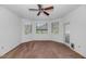Spacious bedroom with neutral carpet, ceiling fan, and a view at 9820 N Central Ave # 303, Phoenix, AZ 85020