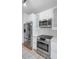 Modern kitchen with stainless steel appliances and white cabinetry at 9820 N Central Ave # 303, Phoenix, AZ 85020