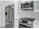 Modern kitchen with stainless steel appliances and white cabinetry at 9820 N Central Ave # 303, Phoenix, AZ 85020
