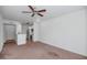 Spacious living room with neutral carpet adjacent to the modern kitchen at 9820 N Central Ave # 303, Phoenix, AZ 85020