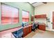 Comfortable home office featuring built in desks, storage, carpet, and natural light with a neutral color scheme at 9820 N Central Ave # 303, Phoenix, AZ 85020