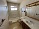 Full bathroom featuring a shower-tub combo, single vanity, and a mirrored medicine cabinet at 10728 W El Rancho Dr, Sun City, AZ 85351