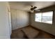 Bright bedroom with a ceiling fan, large window and good closet space at 10728 W El Rancho Dr, Sun City, AZ 85351