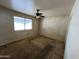 Bright bedroom with a ceiling fan, large window and plenty of natural light at 10728 W El Rancho Dr, Sun City, AZ 85351