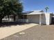 Charming single-story home with a well-maintained lawn, mature tree, and solar panels at 10728 W El Rancho Dr, Sun City, AZ 85351