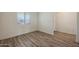 Bright bedroom with wood-look flooring, white walls, and a large window at 1131 W West Virginia Ave, Florence, AZ 85132