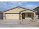 Charming single-story home with a two-car garage and neutral-toned stucco exterior at 1131 W West Virginia Ave, Florence, AZ 85132