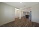 Open-concept living space with modern wood-look flooring and neutral paint at 1131 W West Virginia Ave, Florence, AZ 85132