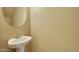 Stylish half bathroom with a pedestal sink and an oval mirror at 1367 S Country Club Dr # 1167, Mesa, AZ 85210