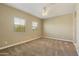 Spacious bedroom featuring neutral tones, carpeted floors, and natural light from two windows at 1367 S Country Club Dr # 1167, Mesa, AZ 85210