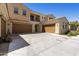 Beige two-story home with brown garages, balcony, and a spacious concrete driveway at 1367 S Country Club Dr # 1167, Mesa, AZ 85210