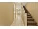 Inviting hallway with tile floors and a carpeted staircase leading to the upper level at 1367 S Country Club Dr # 1167, Mesa, AZ 85210