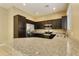 Modern kitchen with stainless steel appliances, dark wood cabinets, and granite counters at 1367 S Country Club Dr # 1167, Mesa, AZ 85210