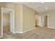 Spacious carpeted living room with multiple doors and neutral-colored walls at 1367 S Country Club Dr # 1167, Mesa, AZ 85210