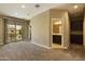 Carpeted upstairs loft with sliding glass doors and a bathroom with a dark vanity at 1367 S Country Club Dr # 1167, Mesa, AZ 85210