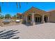 Covered patio with stone columns, pavers, barbeque grill, and views of desert landscaping at 1367 S Country Club Dr # 1167, Mesa, AZ 85210