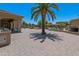Paver patio featuring a community pool, spa, desert landscaping and palm trees at 1367 S Country Club Dr # 1167, Mesa, AZ 85210