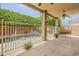 Covered back patio with wrought iron fence surrounding pool and lounge swing at 1391 W Windhaven Ave, Gilbert, AZ 85233
