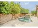 Sparkling backyard pool with lush landscaping, rock waterfall, and ample sunshine at 1391 W Windhaven Ave, Gilbert, AZ 85233