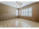 Bright bedroom with tile flooring, neutral walls, and plantation shutters offering privacy and light control at 1391 W Windhaven Ave, Gilbert, AZ 85233