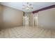 Large bedroom featuring tile floors and access to a hallway, offering versatility and convenience at 1391 W Windhaven Ave, Gilbert, AZ 85233