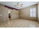 Comfortable bedroom with tile floors and an ensuite bathroom, providing a relaxing retreat at 1391 W Windhaven Ave, Gilbert, AZ 85233