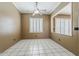 The bedroom offers a ceiling fan, plantation shutters, tile floor, and an open window at 1391 W Windhaven Ave, Gilbert, AZ 85233