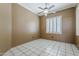 This bedroom features neutral walls, a ceiling fan, plantation shutters and tile floor at 1391 W Windhaven Ave, Gilbert, AZ 85233