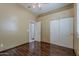 Charming bedroom with wood floors, ceiling fan, and closet with sliding doors at 1391 W Windhaven Ave, Gilbert, AZ 85233