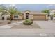 Charming single-story home with desert landscaping and a covered entryway creating curb appeal at 1391 W Windhaven Ave, Gilbert, AZ 85233